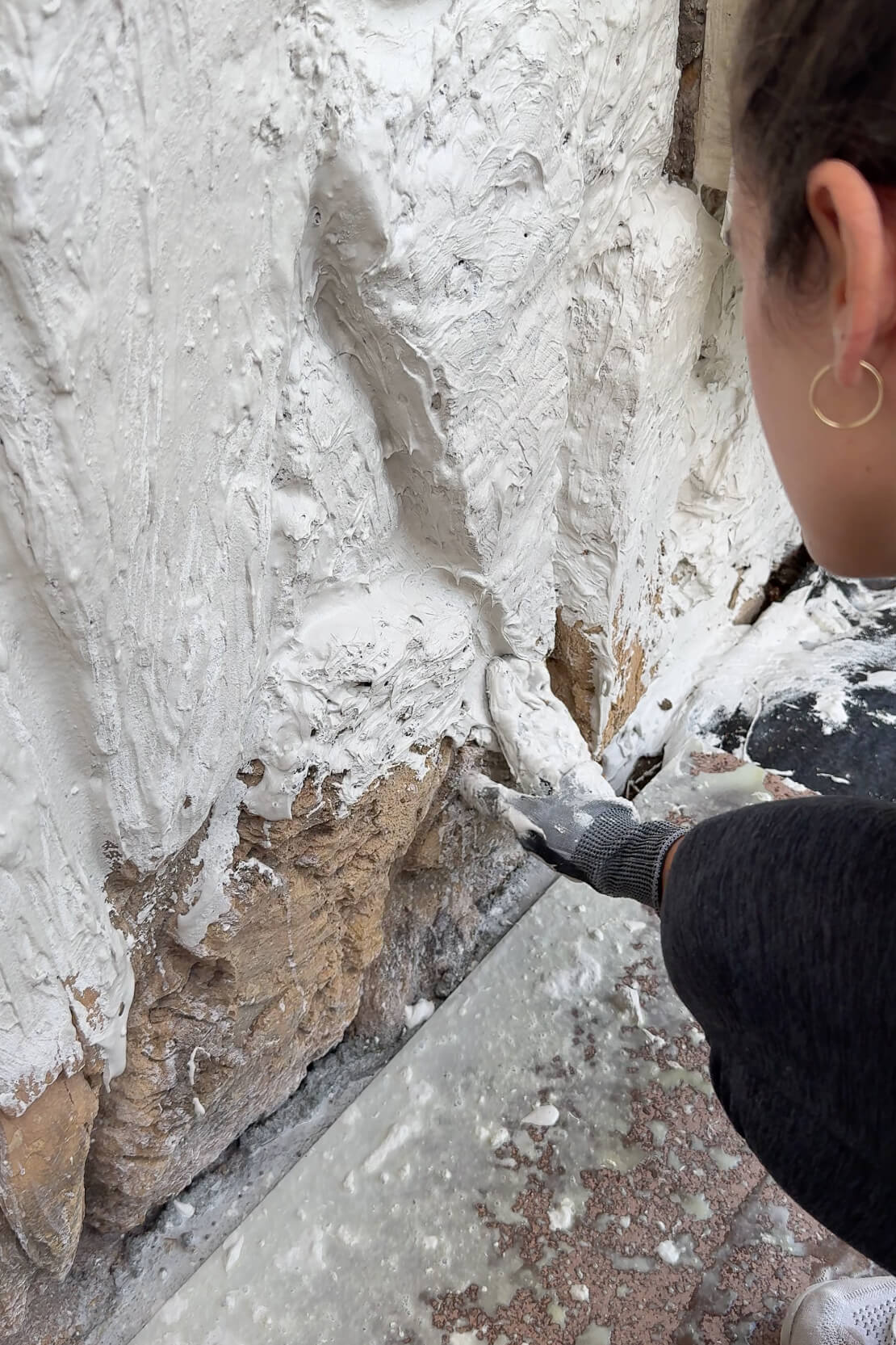 Applying mortar to a dated rock wall. 